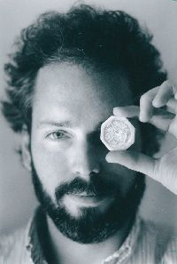 Tommy Thompson holds found treasure coin